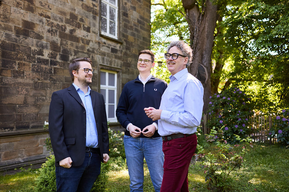 Austausch im DLMC-Team Mitarbeiter der DLMC tauschen sich im Garten des Unternehmens über aktuelle Projekte aus.